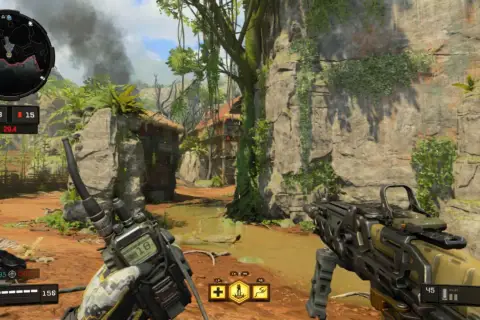 Wojownik w dżungli, gotowy do akcji w kampanii Black Ops 4. W rękach ma broń i krótkofalówkę, a przed nim widać wioskę i skalne ściany.
