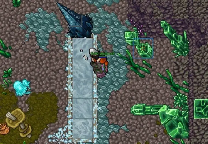 Gracz w grze Tibia zbiera kryształy w jaskini pełnej zielonych i niebieskich minerałów.