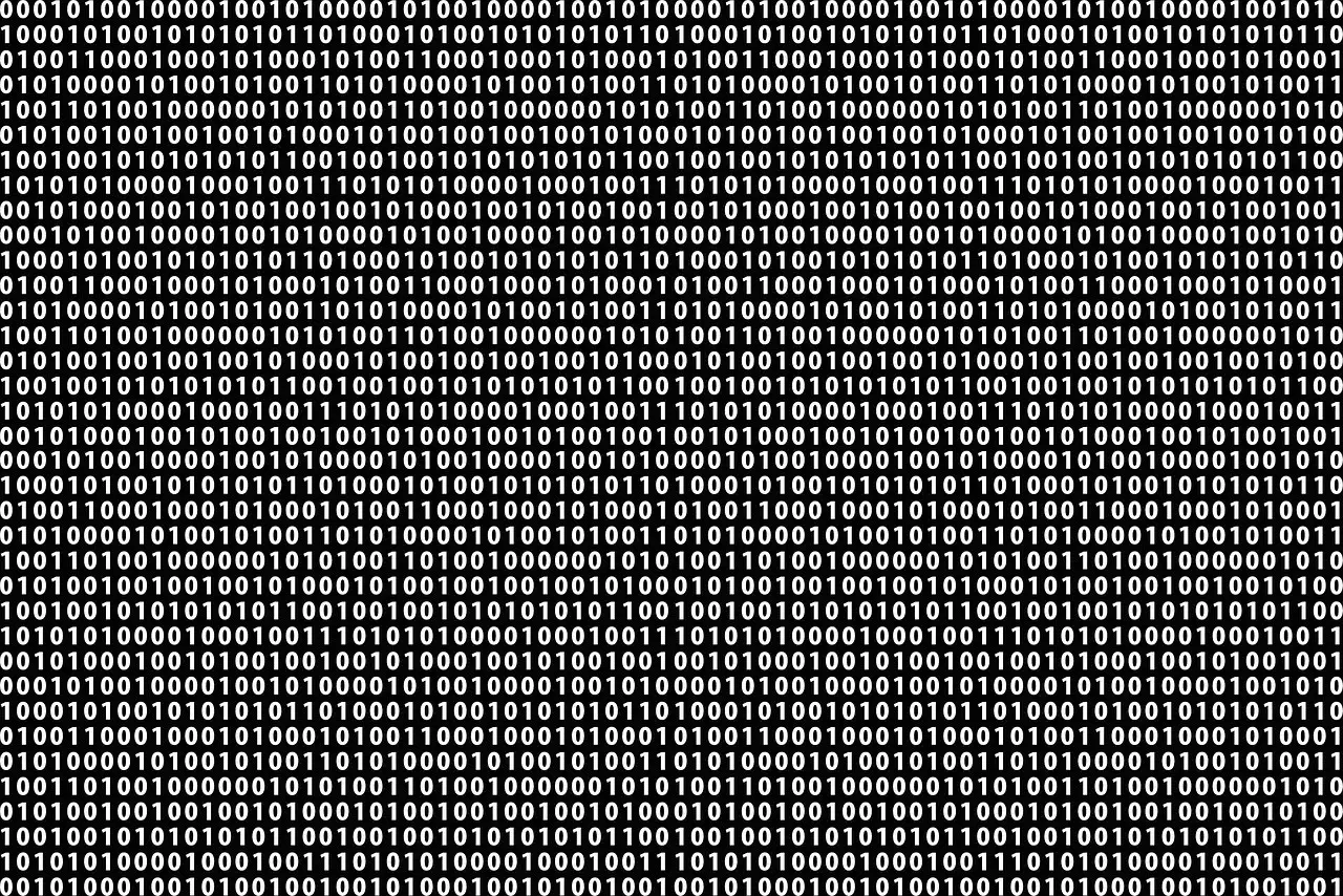 Tło z cyframi 0 i 1, symbolizujące system binarny, kt&oacute;ry zrewolucjonizował informatykę. Kto wymyślił system binarny?