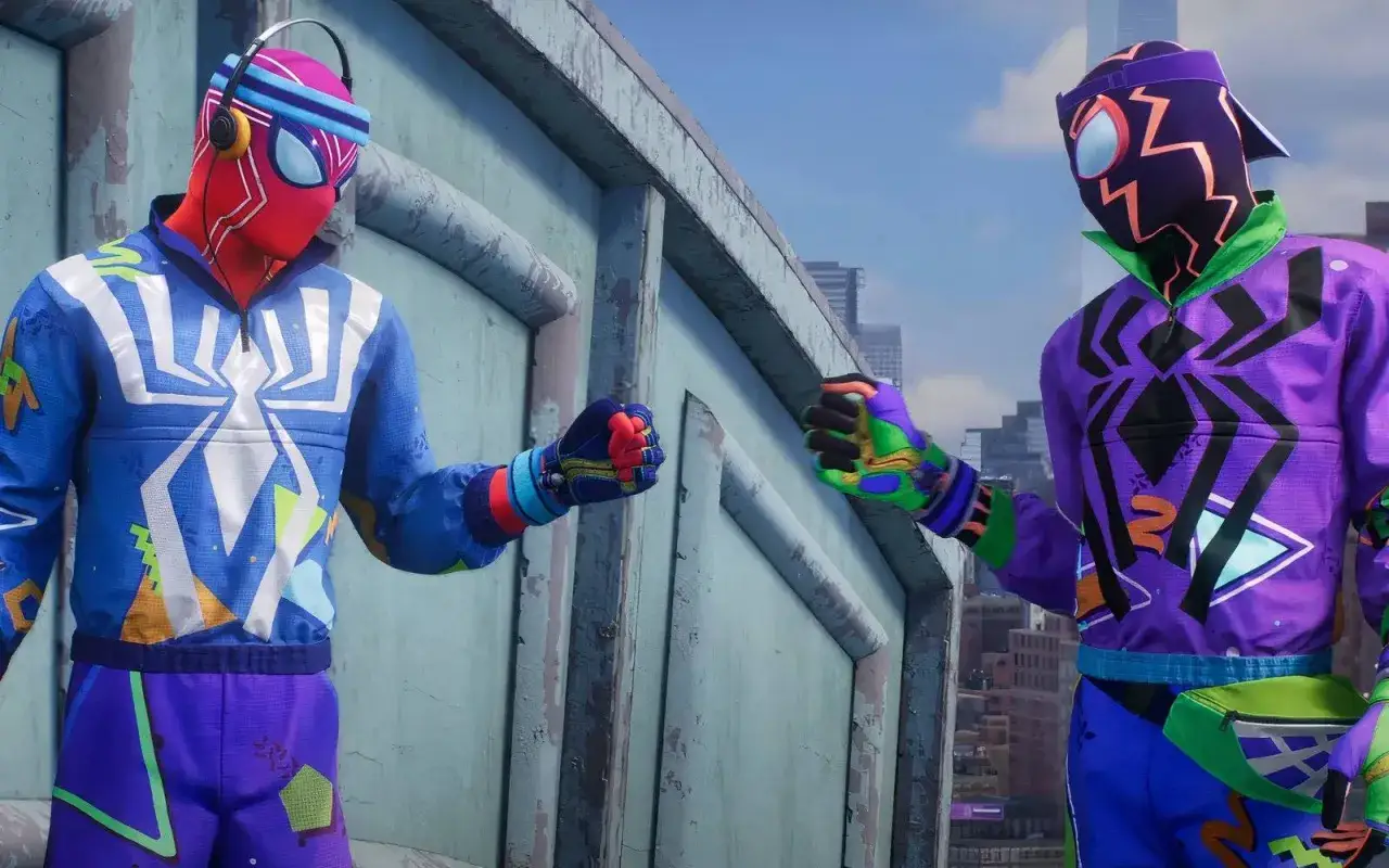 Dwóch Spider-Manów w kolorowych strojach, z elementami nawiązującymi do Spider-Man 2 DLC, pozdrawia się na dachu.